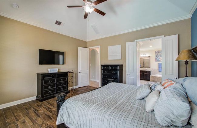 Primary bedroom has a high vaulted ceiling. | Image 31