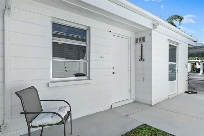 On the side of the house there is another entry door into the dining room and an outdoor shower. | Image 23