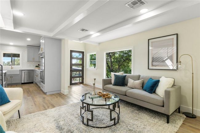 The glass front door graciously opens into the shared living and dining room, complete with LED recessed lighting and warm hardwood flooring that seamlessly connects the living​​‌​​​​‌​​‌‌​‌‌​​​‌‌​​‌‌​‌​​​​​‌ spaces. | Image 7