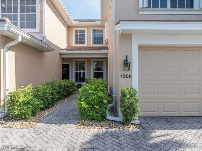 Entrance to property with a garage and stucco siding | Image 12