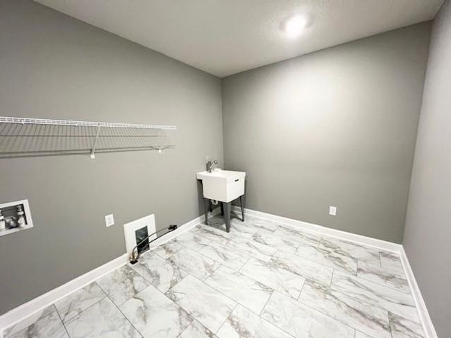 (Photo is of an inventory home, actual homes finishes will vary) Conveniently located on the second level, this plan features upper-level laundry right next to the home's four bedrooms. | Image 23