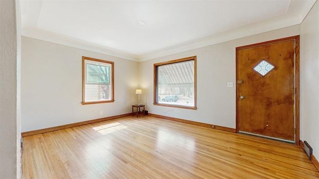 The hardwood floors were recently refinished, adding warmth and charm to the space. Cozy living room filled with natural light. | Image 4