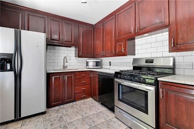 Kitchen featuring stainless steel appliances, tasteful backsplash, and sink | Image 3