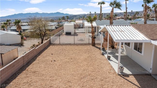 View of yard with a residential view, a patio area, a fenced backyard, and a mountain view | Image 54