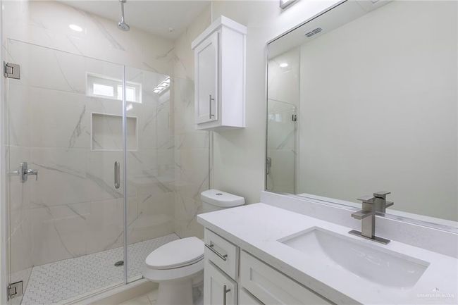 Porcelain Walls on Shower, Frameless Glass Door, Quarz Countertops. | Image 16