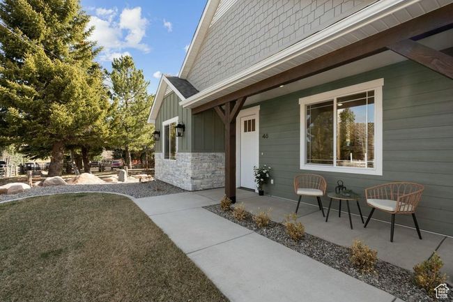 View of side of home featuring board and batten siding and stone siding | Image 44