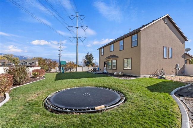 View of yard with a trampoline | Image 26
