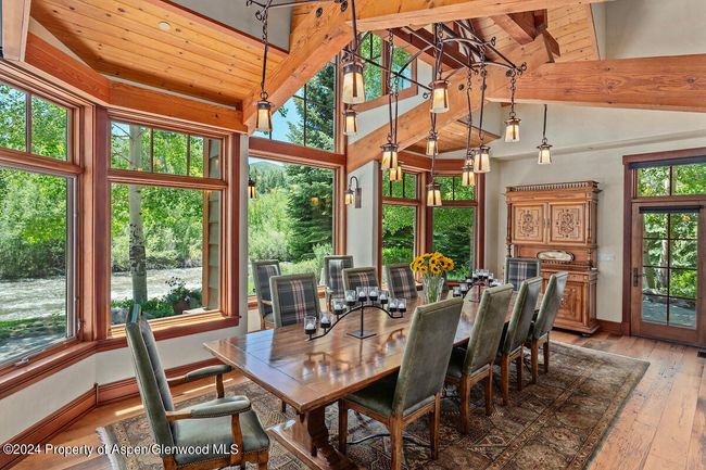 Formal dining room seats up to 16. Table graced with a custom chandelier | Image 22