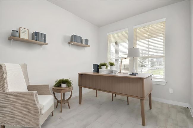 *Virtually Staged* Step into the inviting home office, where elegant tile flooring adds a touch of freshness and comfort to the workspace. Natural light pours through the window, creating an inspiring environment for productivity and focus. | Image 8