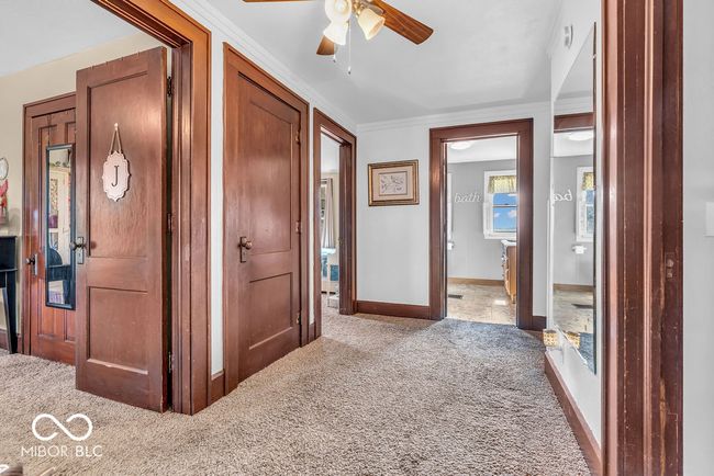 hall featuring carpet floors and baseboards | Image 30