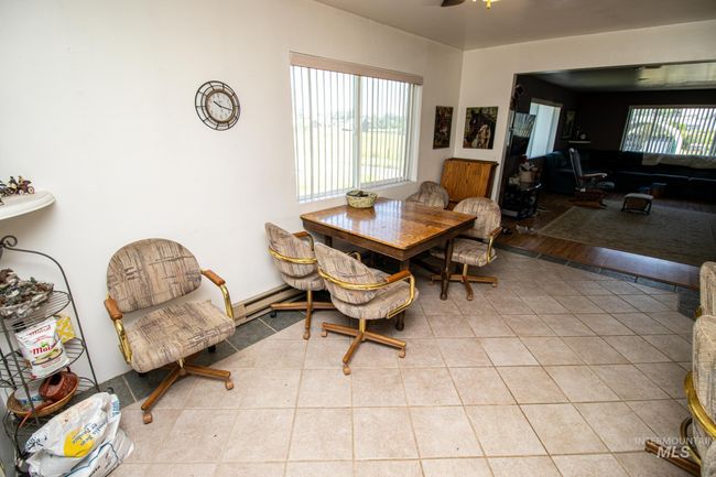 Tiled dining area featuring plenty of natural light and ceiling fan | Image 16