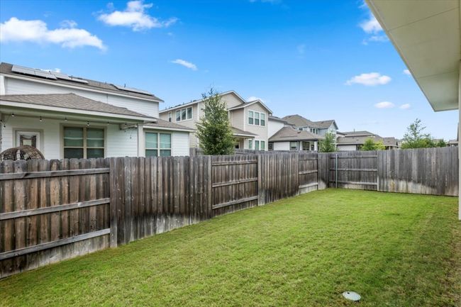 Fenced backyard featuring a residential view | Image 23