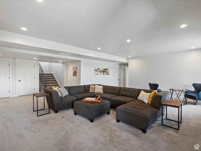 Living area with light carpet, recessed lighting, and stairs | Image 46
