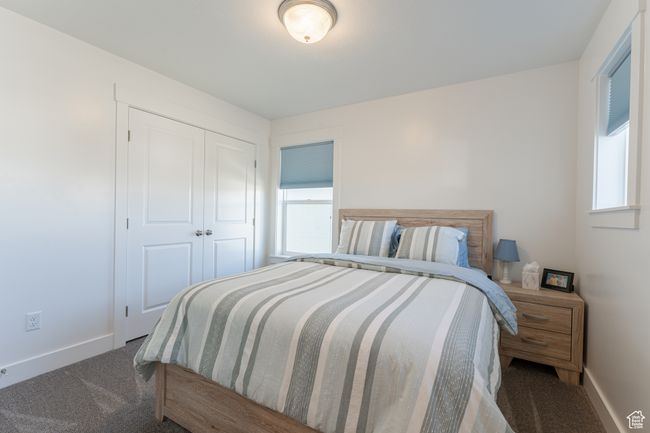 Carpeted bedroom with a closet, baseboards, and multiple windows | Image 13