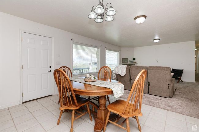 Dining room featuring a chandelier and light tile patterned floors | Image 35