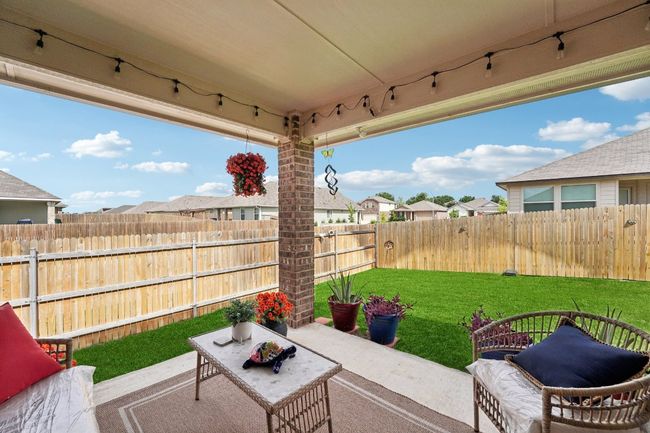 Fenced backyard with a patio area and a residential view | Image 29