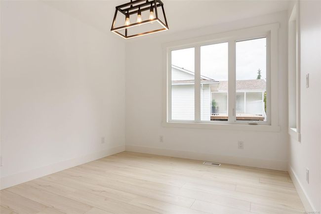 Bright dining area off kitchen with access to back deck | Image 18