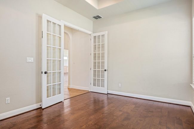 Spare room with french doors, dark wood-style flooring, and arched walkways | Image 32