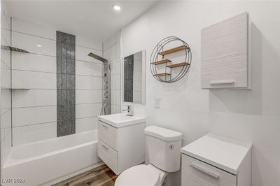 Meticulously crafted bathroom with luxury rainfall design tile, shower panel with LED temperature display, body jets, shower wand and tub filler with floating vanities for storage and easy cleaning. | Image 1