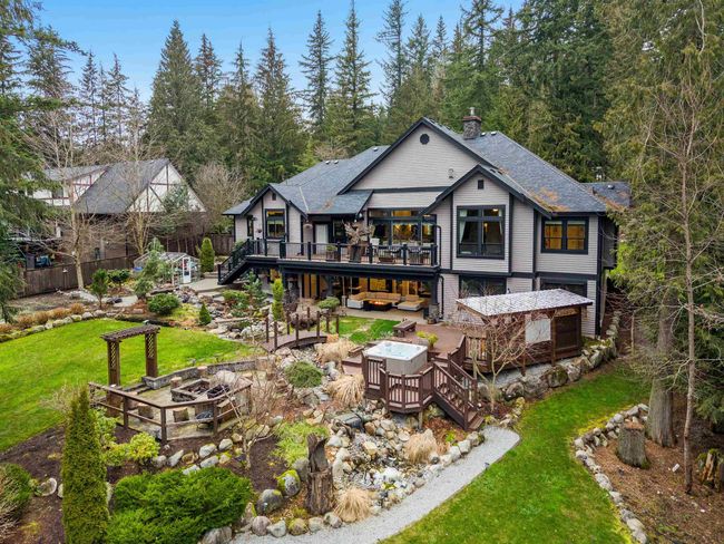 Rear view of house with a deck, fence, a yard, stairway, and an outdoor living space with a fire pit | Image 38