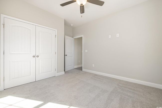 Unfurnished bedroom featuring a closet, ceiling fan, and light colored carpet | Image 24