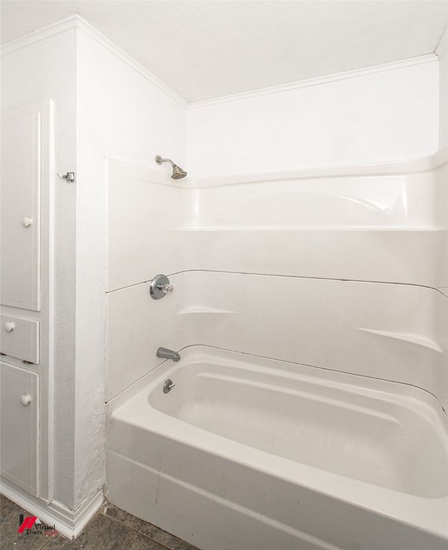 Bathroom featuring bathing tub / shower combination | Image 5