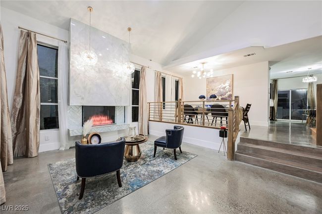 Living room with Electric Fireplace, Vaulted Ceilings and Ceiling to floor tile wall | Image 6