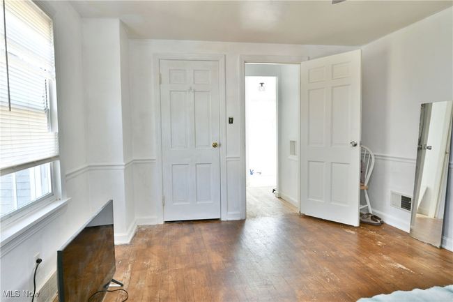 Unfurnished bedroom featuring hardwood / wood-style floors and visible vents | Image 35