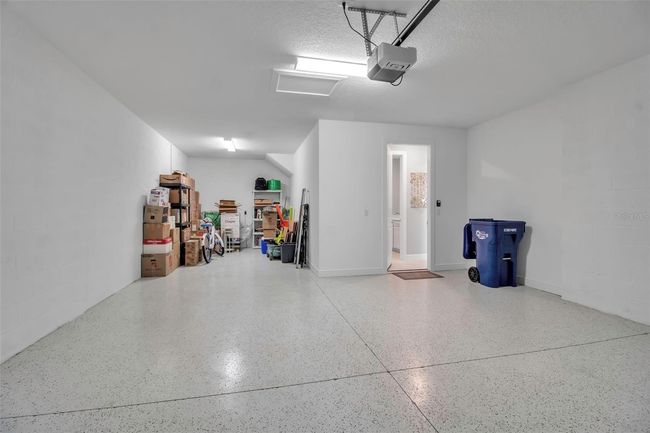 Garage has epoxy floor and the golf cart/ workshop/storage space plus space for two cars | Image 54