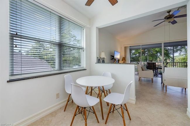 Dining room with vaulted ceiling, light tile patterned floors, and ceiling fan | Image 11