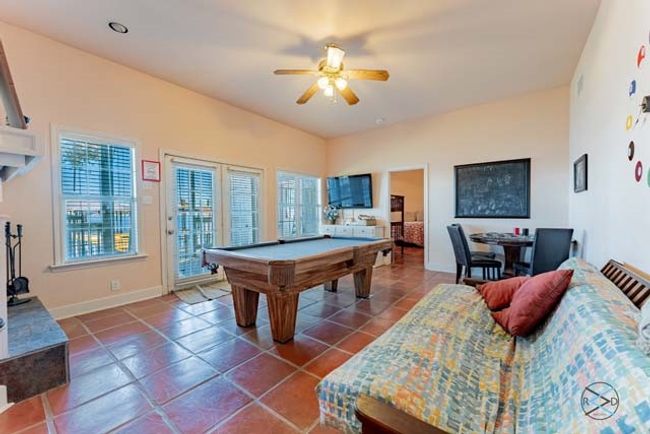 Downstairs walk-out game room offers a wood burning fireplace and full bath. | Image 24