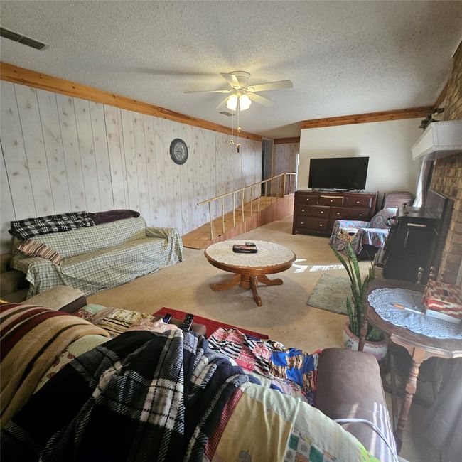 Carpeted living room with ceiling fan, a Another view of living room | Image 22