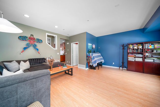 Living room with visible vents, baseboards, wood finished floors, and recessed lighting | Image 27