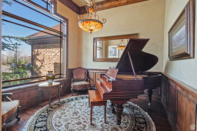 Sitting room with crown molding, a wainscoted wall, a chandelier, and hardwood / wood-style flooring | Image 27