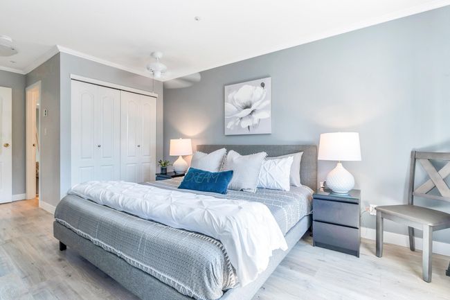 Bedroom with a closet, baseboards, wood finished floors, and ornamental molding | Image 18