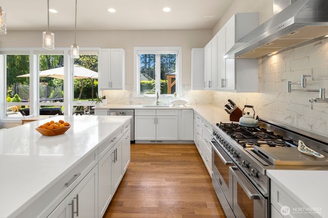 Thoughtful design touches abound, like a backyard view from the sink, and pot-filler at the range. | Image 11
