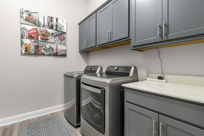 Laundry with added storage cabinetry | Image 29