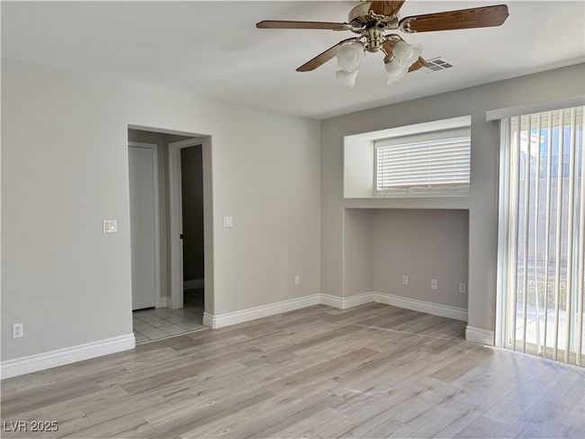Spare room featuring visible vents, baseboards, a ceiling fan, and light wood finished floors | Image 18