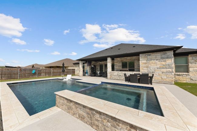 View of pool featuring a fenced backyard, a pool with connected hot tub, and a patio | Image 37