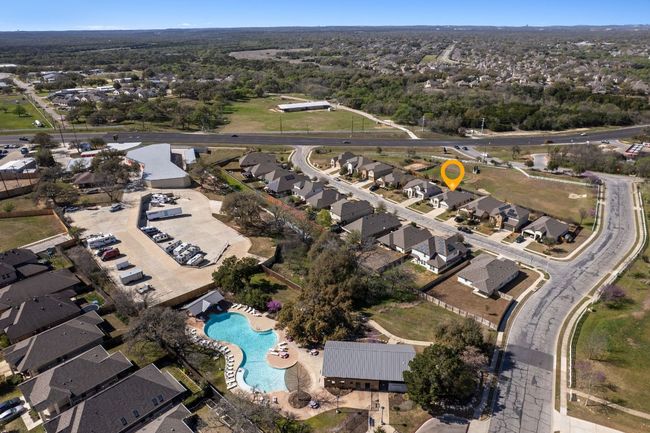 Aerial view highlighting the proximity of the home to the amenity center/pool area, easy access to the neighborhood's entrance, and FM 1626 | Image 36