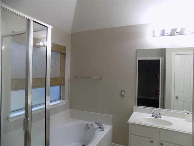 Bathroom featuring a bath, vanity, and a stall shower | Image 22