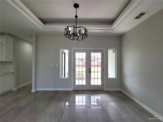 Doorway to outside with an inviting chandelier, french doors, and a raised ceiling | Image 8
