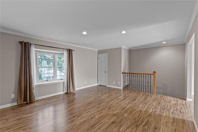 Empty room with hardwood / wood-style floors and crown molding | Image 2