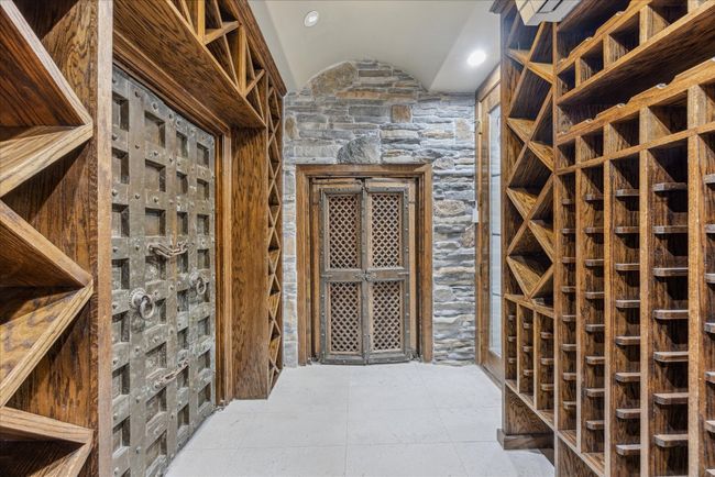 The wine grotto is fabulous for a wine collector, and is adorned with antique dungeon doors. | Image 27