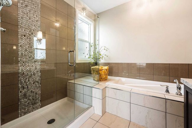 Full bath with a shower stall, tile patterned flooring, and a bath | Image 24