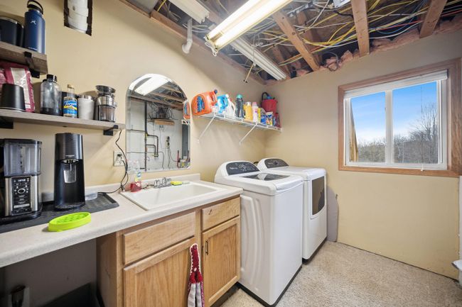 Lower level utility room with a sink. | Image 21