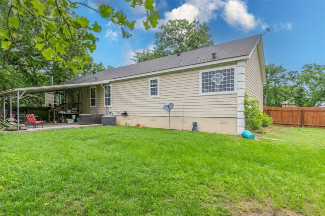 Rear view of property featuring a lawn, a patio area, fence, and crawl space | Image 22