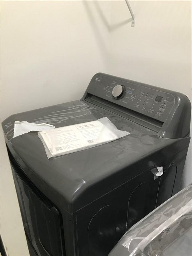 Clothes washing area with washer / dryer | Image 14