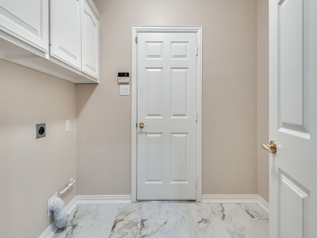 Full size laundry room with room for refrigerator or freezer. The dryer area is plumbed for a gas or electric dryer. | Image 22