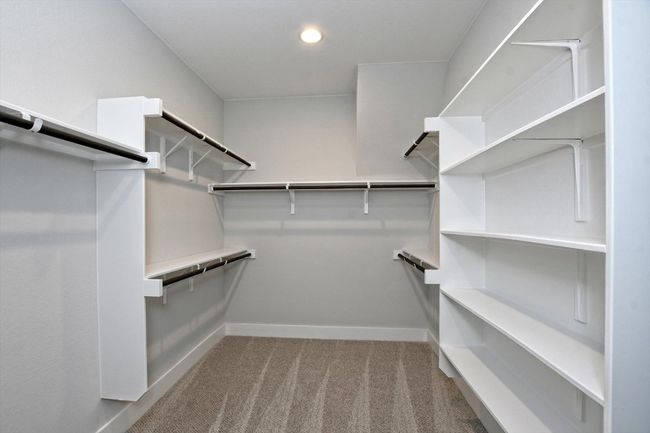 Walk in closet featuring carpet flooring | Image 17